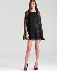 Float on in Bailey 44's cape-inspired silhouette--sheer chiffon subdues a sparkling sequin lining. Float on in Bailey 44's cape-inspired silhouette--sheer chiffon subdues a sparkling sequin lining.
