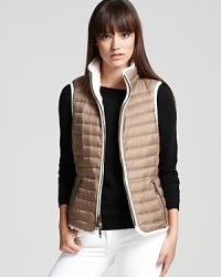 A style chameleon, this Burberry Brit vest reverses from a classic cable-knit silhouette to a utilitarian puffer style for a fashionable yet functional look. A style chameleon, this Burberry Brit vest reverses from a classic cable-knit silhouette to a utilitarian puffer style for a fashionable yet functional look.