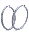 Fashion that covers all bases. These sleek hoop earrings from GUESS sparkle inside and out with glass accents. Crafted in silver tone mixed metal. Approximate diameter: 2 inches.