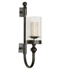 The gracefully twisted metal arm of the Garvin wall sconce plays up its lean profile, which is enhanced by the black metal finish accented with red rust highlights. The finished look is impeccable and poised, just right for traditional settings where every detail counts.