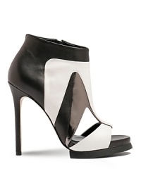 A sandal-bootie hybrid, Camilla Skovgaard's Eye Cut sandals boast a color block design in desaturated shades. A sandal-bootie hybrid, Camilla Skovgaard's Eye Cut sandals boast a color block design in desaturated shades.