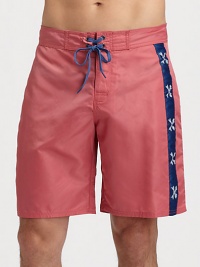 Bold, contrasting side stripes adorn these classic-fitting swim trunks, set in quick-drying nylon for superior fit and comfort.Drawstring waistRear flap pocketInseam, about 9NylonMachine washImported Bold, contrasting side stripes adorn these classic-fitting swim trunks, set in quick-drying nylon for superior fit and comfort.Drawstring waistRear flap pocketInseam, about 9NylonMachine washImported