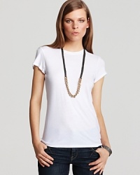 This basic tee from Vince is a perennial wardrobe essential, perfect for layering under a cardigan or on its own with our skinny jeans. This basic tee from Vince is a perennial wardrobe essential, perfect for layering under a cardigan or on its own with our skinny jeans.