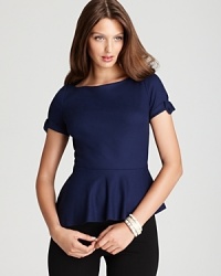 An asymmetric hem brings edge to Elie Tahari's peplum blouse, dressed up with grosgrain trim. An asymmetric hem brings edge to Elie Tahari's peplum blouse, dressed up with grosgrain trim.