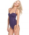 Calvin Klein's one-piece mixes the classic glamour of corset styling with the modern edge of metal studs. Wear it as a halter, crisscross back, a traditional over-the-shoulder swimsuit or a sexy strapless bandeau.