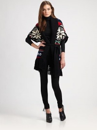 Oversized intarsia snowflakes and borders, bright colors and lots of fringe give this chunky sweater vest a festive air.Wide, ribbed shawl collarShort dolman sleeves with ribbed trimOpen frontSelf tie beltFringed hemAbout 27 from shoulder to hemCotton/cashmere/angoraDry cleanImportedSIZE & FITModel shown is 5'10 (177cm) wearing US size Small. Oversized intarsia snowflakes and borders, bright colors and lots of fringe give this chunky sweater vest a festive air.Wide, ribbed shawl collarShort dolman sleeves with ribbed trimOpen frontSelf tie beltFringed hemAbout 27 from shoulder to hemCotton/cashmere/angoraDry cleanImportedSIZE & FITModel shown is 5'10 (177cm) wearing US size Small.