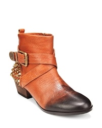 Prickly pair: These Western boots flaunt saucy spiked studs at the back for a bit of moto mojo; vintage-look leather and harness wraps tie up the look; from VINCE CAMUTO. Prickly pair: These Western boots flaunt saucy spiked studs at the back for a bit of moto mojo; vintage-look leather and harness wraps tie up the look; from VINCE CAMUTO.