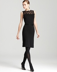 A sheer lace neckline lends dark romance to a classic Tory Burch dress for a demure yet dramatic look. A sheer lace neckline lends dark romance to a classic Tory Burch dress for a demure yet dramatic look.