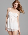 This romantic set includes a ruffle-trimmed camisole and shorts with bow details.