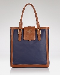 Upgrade your day bag with this coated canvas tote from Tory Burch. A simple yet spacious design and buckled detailing make this practical style an ever-chic choice. Upgrade your day bag with this coated canvas tote from Tory Burch. A simple yet spacious design and buckled detailing make this practical style an ever-chic choice.