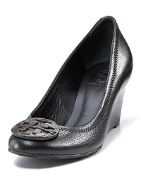Classic Tory Burch leather wedge pumps with leather logo ornamentation at toe. Classic Tory Burch leather wedge pumps with leather logo ornamentation at toe.
