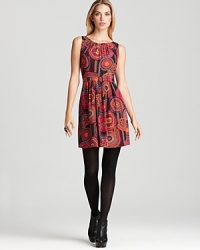 Circular multi-colored medallions enrich this beautiful Trina Turk dress with warm autumnal colors and a flattering banded waist lends a slimming, feminine silhouette. Circular multi-colored medallions enrich this beautiful Trina Turk dress with warm autumnal colors and a flattering banded waist lends a slimming, feminine silhouette.