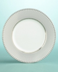 This lacey design was inspired by an antique transferware place setting. The innovation of copperplate engraving was 'transferred' to pottery in the 18th and 19th centuries, newly allowing fine details to be rendered on ceramic glazes. The luminous fine china French Knot dinner plates are encircled with delicate filagree patterned bands. Accent plates are intricately laced with a border-wide network of tiny filagree dots, like a deft hand-embroidery, or an exquisite Tønder lace.