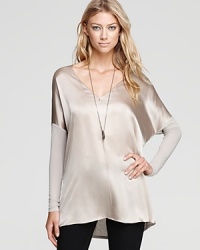 Soft knit sleeves enrich this silk Vince top for a beautiful contrast--its flowy drape paired atop skinny jeans lends for a stylish variation in silhouettes. Soft knit sleeves enrich this silk Vince top for a beautiful contrast--its flowy drape paired atop skinny jeans lends for a stylish variation in silhouettes.