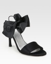 Glimmering satin with an oversized bow, elastic slingback strap and skinny heel. Self-covered heel, 4 (100mm)Satin upperLeather lining and solePadded insoleImportedOUR FIT MODEL RECOMMENDS ordering true size. 