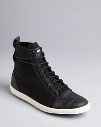 Nike picks up urban style influences in these canvas high top sneakers-meet-booties. Get ready to kick it around town. Nike picks up urban style influences in these canvas high top sneakers-meet-booties. Get ready to kick it around town.