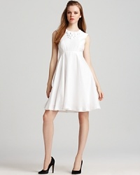 Be detail oriented this spring in a white Milly dress featuring two buttons at the neckline, a feminine pleated skirt and a cutout at the back. Perfect for your next daytime party, the polished silhouette becomes complete with glossy black patent pumps. Be detail oriented this spring in a white Milly dress featuring two buttons at the neckline, a feminine pleated skirt and a cutout at the back. Perfect for your next daytime party, the polished silhouette becomes complete with glossy black patent pumps.