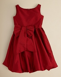 An on-trend bubble dress in bright red sateen with a sash and bow at the hip. An on-trend bubble dress in bright red sateen with a sash and bow at the hip.