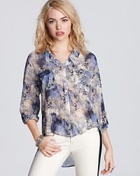 Let your wild side run free in a Free People abstract animal print top. Complete with a high/low hem, this blouse instantly adds pizazz to your favorite jeans. Let your wild side run free in a Free People abstract animal print top. Complete with a high/low hem, this blouse instantly adds pizazz to your favorite jeans.