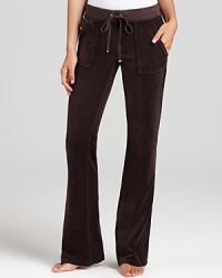 Snap-patch back pockets lend a utility-inspired feel to Juicy Couture's signature velour lounge pants. Snap-patch back pockets lend a utility-inspired feel to Juicy Couture's signature velour lounge pants.