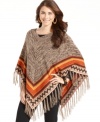 A vibrant tribal pattern and fringed hemline makes this marled poncho a must-have. From NY Collection.