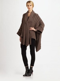 A chunky-knit, draped silhouette is joined together with a front pin detail.Pinned frontLong sleevesHi-low hemAbout 32 from shoulder to hem(at longest length)WoolDry cleanMade in ItalyModel shown is 5'11 (180cm) wearing US size Small. A chunky-knit, draped silhouette is joined together with a front pin detail.Pinned frontLong sleevesHi-low hemAbout 32 from shoulder to hem(at longest length)WoolDry cleanMade in ItalyModel shown is 5'11 (180cm) wearing US size Small.