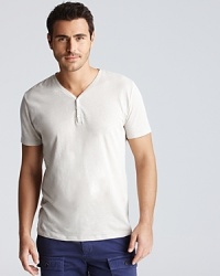 A linen and cotton blend create a naturally flowing drape to the v neck cotton henley. A linen and cotton blend create a naturally flowing drape to the v neck cotton henley.