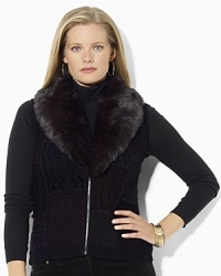 A superbly soft faux-beaver trim glamorously accents a chic knit vest with a timeless patchwork pattern. A superbly soft faux-beaver trim glamorously accents a chic knit vest with a timeless patchwork pattern.