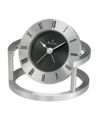 Contemporary flair marks this bedside alarm clock by Bulova. Spun and brushed aluminum frame holds a round pivoting case. Bezel etched with black Roman numerals and black dial features two silver tone hands. Features beep alarm. Contemporary flair marks this bedside alarm clock by Bulova. Spun and brushed aluminum frame holds a round pivoting case. Bezel etched with black Roman numerals and black dial features two silver tone hands. Features beep alarm.