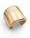 An antiqued gold cuff made from metallic resin, with a wide tapered form, exudes classic simplicity.Goldplated resin Width, about 2½ Diameter, about 2 Made in USA