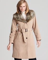 This Calvin Klein trench coat gets a glamorous update with a faux fur neckline--a luxe twist on the perennial favorite. This Calvin Klein trench coat gets a glamorous update with a faux fur neckline--a luxe twist on the perennial favorite.