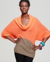 Fall dressing calls for rich color block accents and generous necklines for cozy-chic warmth and style.