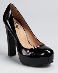 Glossy patent leather gleams on Pour La Victoire's Irina II platform pumps. Pair them with a metallic clutch for a statement making look. Glossy patent leather gleams on Pour La Victoire's Irina II platform pumps. Pair them with a metallic clutch for a statement making look.
