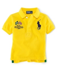 A preppy short-sleeved polo shirt in breathable cotton mesh is accented with country embroidery, celebrating Team USA's participation in the 2012 Olympics. A preppy short-sleeved polo shirt in breathable cotton mesh is accented with country embroidery, celebrating Team USA's participation in the 2012 Olympics.