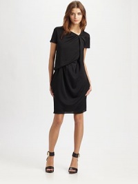 High-fashion silhouette styled with an asymmetrical v-neck, short sleeves and modern draping. Asymmetrical v-neckShort sleevesBack button closureAbout 21 from natural waistPolyesterDry cleanImportedModel shown is 5'10 (177cm) wearing US size 4. High-fashion silhouette styled with an asymmetrical v-neck, short sleeves and modern draping. Asymmetrical v-neckShort sleevesBack button closureAbout 21 from natural waistPolyesterDry cleanImportedModel shown is 5'10 (177cm) wearing US size 4.
