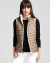 A style chameleon, this Burberry Brit vest reverses from a classic cable-knit silhouette to a utilitarian puffer style for a fashionable yet functional look.