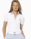 A chic short-sleeved mesh polo is finished with striped oxford-woven details for a preppy, athletic look.