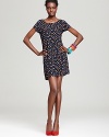 A retro-stylish pop of dots enliven this thoroughly modern silhouette for a look that makes a lasting first impression.