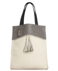 Rock the colorblock trend with this tall tote design from Carlos by Carlos Santana. Ultra-sleek and outfitted with zipper and tassel accents, it's practically posed to meet all your daily demands. Rock the colorblock trend with this tall tote design from Carlos by Carlos Santana. Ultra-sleek and outfitted with zipper and tassel accents, it's practically posed to meet all your daily demands.