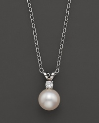 A cultured pearl pendant necklace on a chain. A cultured pearl pendant necklace on a chain.