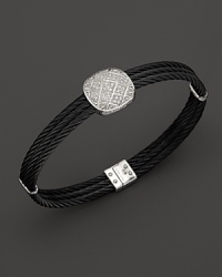 Diamonds set in white gold add glamour to black PVD cable. By Charriol.