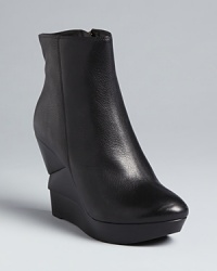These sculptural DIANE von FURSTENBERG wedge booties lend architectural appeal to wear-daily booties. These sculptural DIANE von FURSTENBERG wedge booties lend architectural appeal to wear-daily booties.