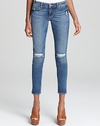 Allover fading with distressed details lends an authentic vintage patina to these Paige Denim skinny jeans, cropped at the ankles for a fresh silhouette. Allover fading with distressed details lends an authentic vintage patina to these Paige Denim skinny jeans, cropped at the ankles for a fresh silhouette.