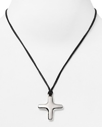A plated silver cross pendant is a Gothic focal point on this Robert Lee Morris Soho necklace comprised of matte black cord. A plated silver cross pendant is a Gothic focal point on this Robert Lee Morris Soho necklace comprised of matte black cord.