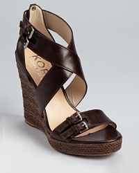 Tall and towering, these KORS Michael Kors wedges showcase smooth leather and buckle details, but the braided texture on the sole steals the show. Tall and towering, these KORS Michael Kors wedges showcase smooth leather and buckle details, but the braided texture on the sole steals the show.