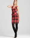 Enriched by a timeless tartan plaid, this classic-chic Trina Turk dress flaunts a charming ladylike peplum in a flattering knee-skimming silhouette.
