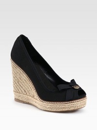 A textured espadrille wedge lifts this canvas peep toe design with a logo-detailed bow. Covered wedge, 4¼ (110mm)Covered platform, 1 (25mm)Compares to a 3¼ heel (80mm)Canvas upperPeep toeCanvas liningRubber solePadded insoleMade in Spain A textured espadrille wedge lifts this canvas peep toe design with a logo-detailed bow. Covered wedge, 4¼ (110mm)Covered platform, 1 (25mm)Compares to a 3¼ heel (80mm)Canvas upperPeep toeCanvas liningRubber solePadded insoleMade in Spain