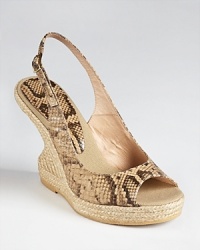 A fashion-forward silhouette usually reserved for evening is updated for day by Andre Assous--the Bev slingback wedges boast a unique curved cut-out heel and python embossed leather. A fashion-forward silhouette usually reserved for evening is updated for day by Andre Assous--the Bev slingback wedges boast a unique curved cut-out heel and python embossed leather.