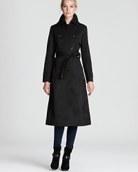 Reign stylishly supreme in this DKNY raincoat with all the details inclement weather requires: a removable hood, lined pockets and buckled cuffs. Padded shoulders add structure for a dose of drama. Reign stylishly supreme in this DKNY raincoat with all the details inclement weather requires: a removable hood, lined pockets and buckled cuffs. Padded shoulders add structure for a dose of drama.