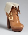 Be the bomb in these bomber-jacket style Rachel Zoe booties. Golden buckles and plush shearling add luxe touches.